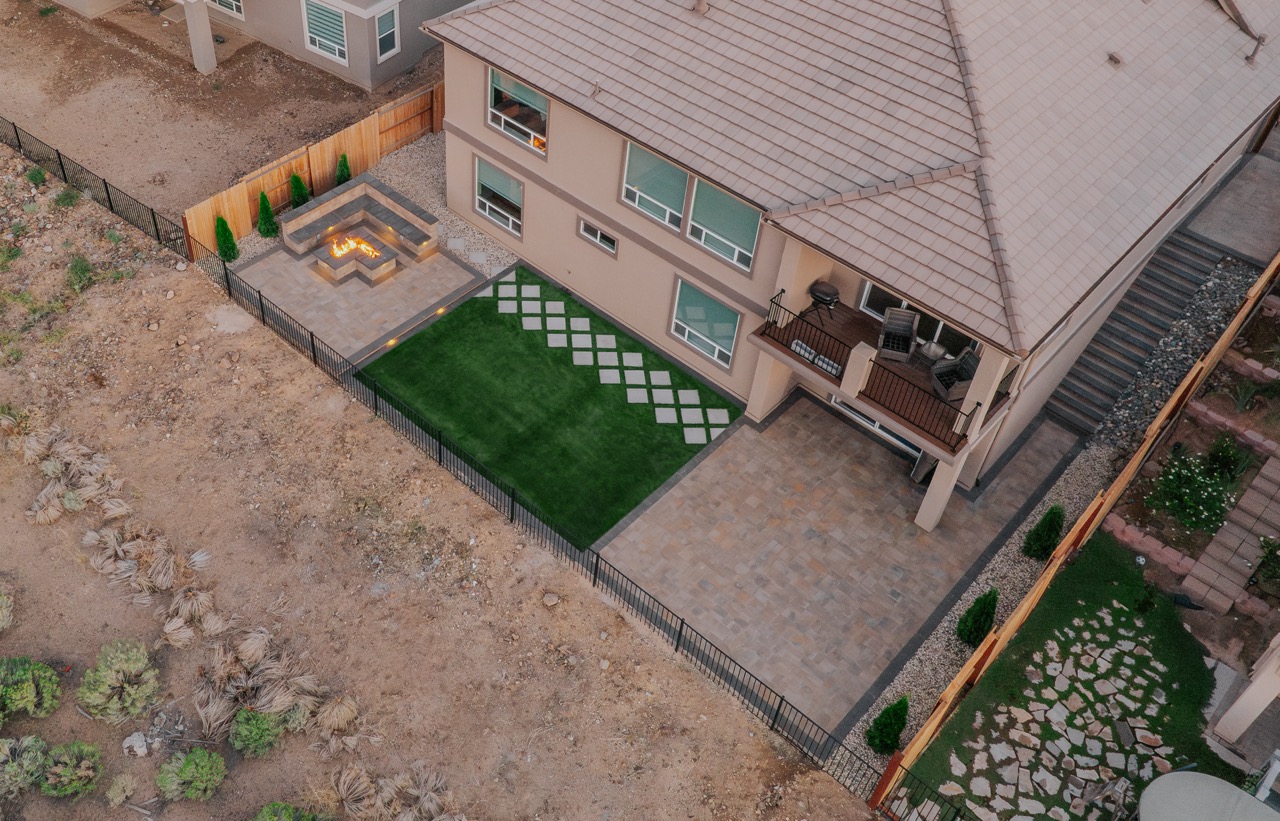 Artificial turf lawn and paver patio in a finished Reno backyard